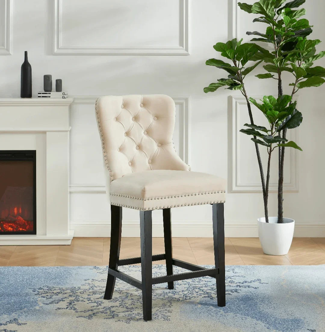 Cream tufted upholstered bar stool with black wooden legs in a modern living room