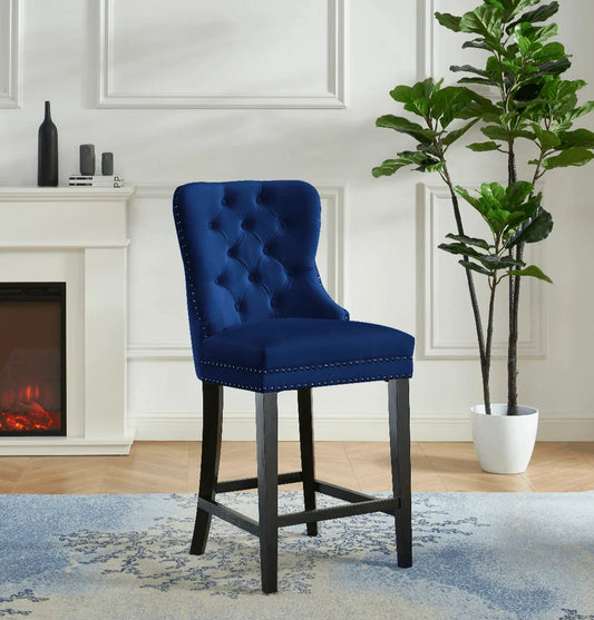 Blue velvet tufted bar stool with black legs in a modern living room setting