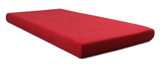 Red rectangular foam mattress pad on a white background